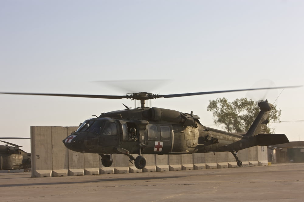 A US Army medevac UH-60 Black Hawk takes off from Camp Speicher Canvas Art - Terry MooreStocktrek Images (18 x 12)