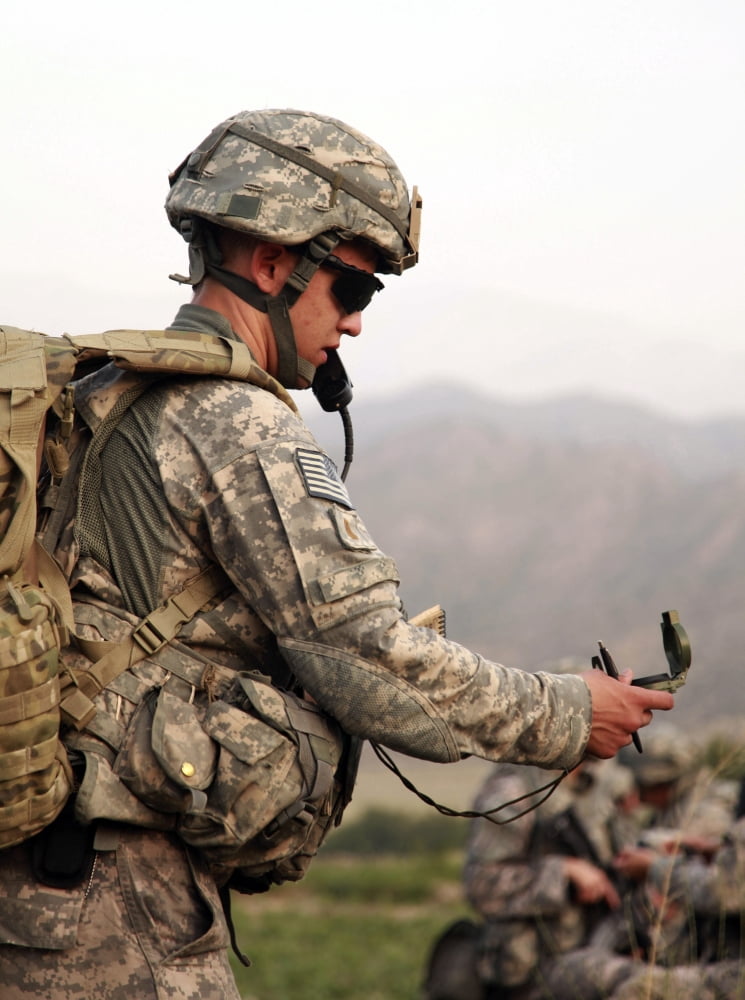 A US Army soldier checking his compass in the Khost province of Afghanistan Canvas Art - Stocktrek Images (25 x 33)