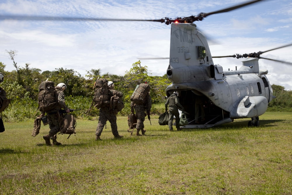 A US Marine Corps CH-46E Sea Knight embarks Marines for transportation Canvas Art - Stocktrek Images (35 x 23)