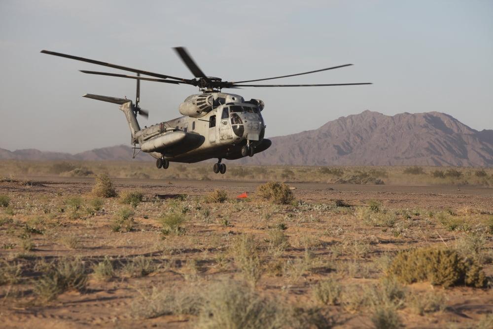 A US Marine Corps CH-53 Sea Stallion helicopter lands to pick up Marines Canvas Art - Stocktrek Images (35 x 23)