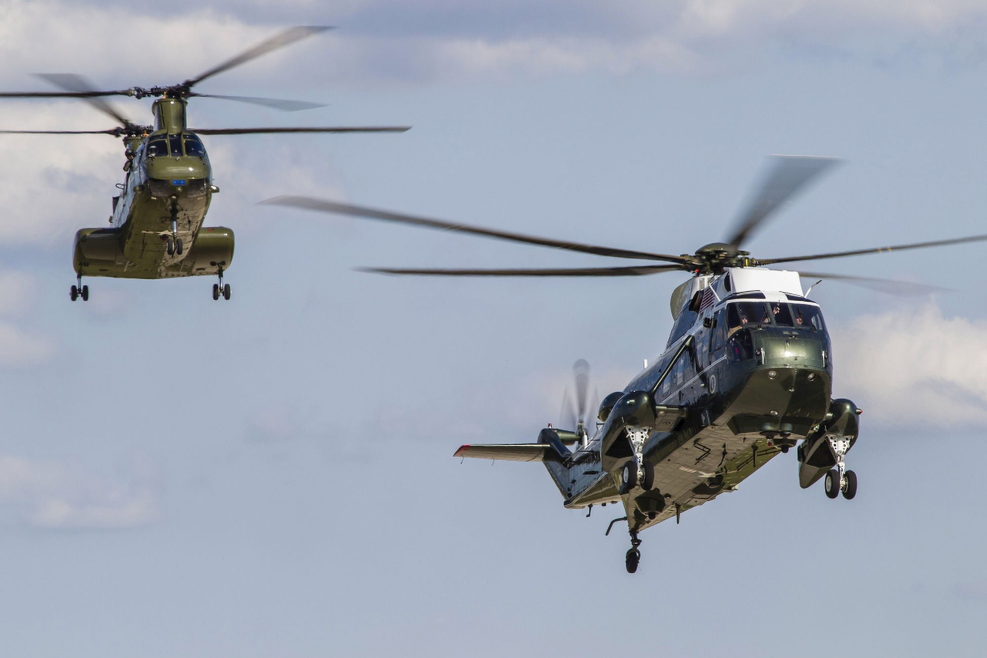 A US Marine Corps VH-3D transport helicopter with a CH-46E Sea Knight behind Canvas Art - Rob EdgcumbeStocktrek Images (35 x 23)