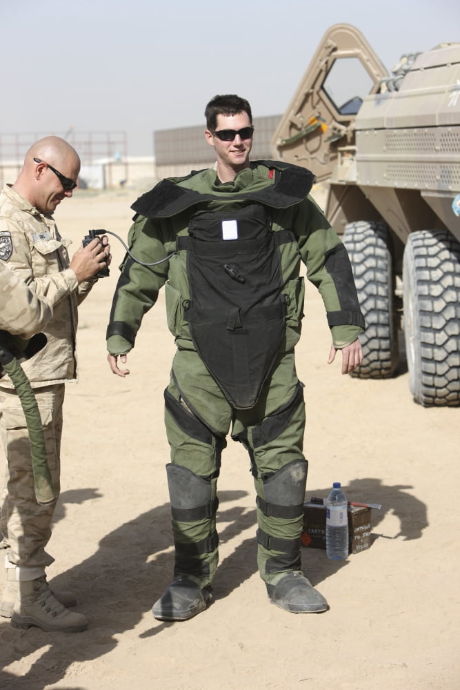 A US Marine gets suited up into a bomb suit Canvas Art - Terry MooreStocktrek Images (12 x 18)