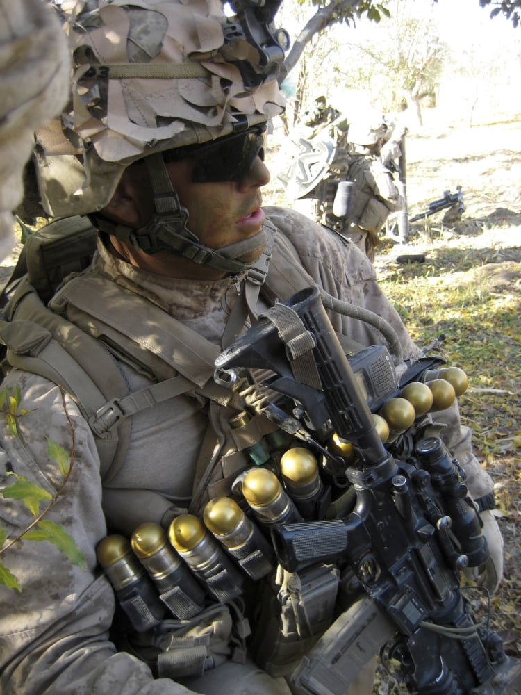 A US Marine takes cover in an orchard in the Now Zad Valley Afghanistan Canvas Art - Stocktrek Images (25 x 33)