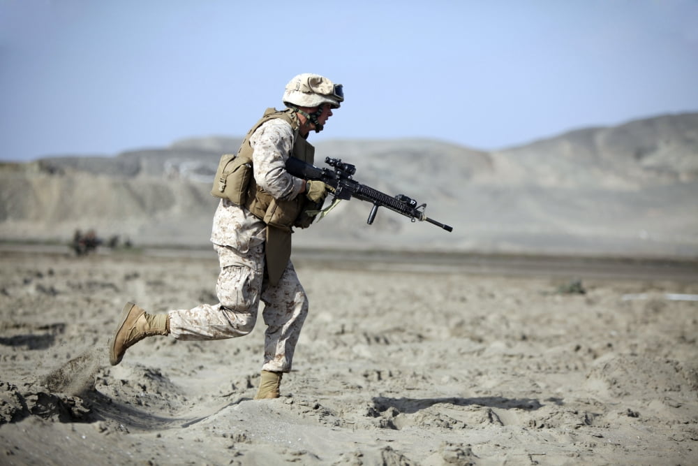 A US Marines runs across the beach during a beach assault in Salinas Peru Canvas Art - Stocktrek Images (34 x 23)