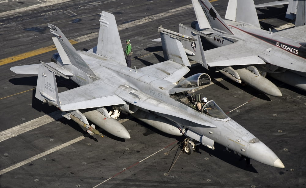 A US Navy FA-18C Hornet parked on the flight deck of USS Nimitz Canvas Art - Giovanni CollaStocktrek Images (36 x 22)