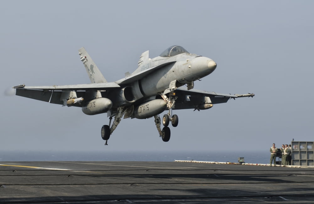 A US Navy FA-18C Hornet prepares to land aboard USS Eisenhower Canvas Art - Giovanni CollaStocktrek Images (35 x 23)