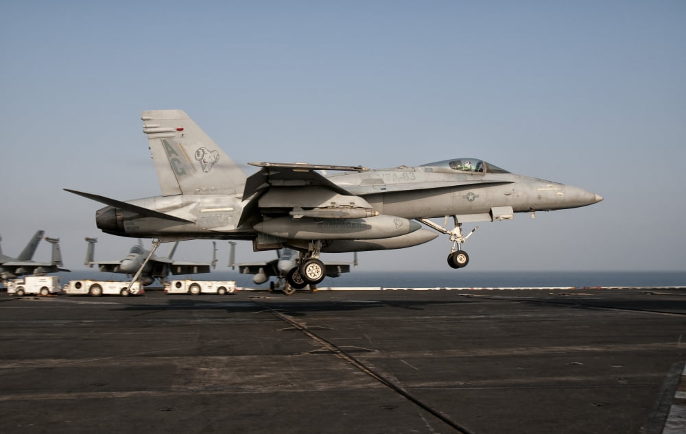 A US Navy FA-18C Hornet prepares to land aboard USS Eisenhower Canvas Art - Giovanni CollaStocktrek Images (35 x 23)