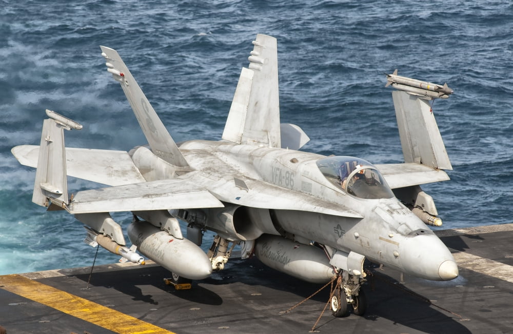A US Navy FA-18C Hornet tied on the flight deck of USS Nimitz Canvas Art - Giovanni CollaStocktrek Images (18 x 12)