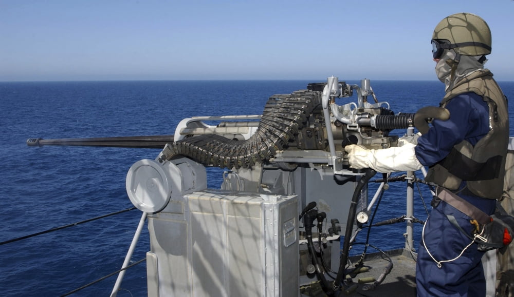 A US Navy Gunners Mate firing a 50-caliber machine gun during weapons training aboard USS Boxer Canvas Art - Stocktrek Images (37 x 22)
