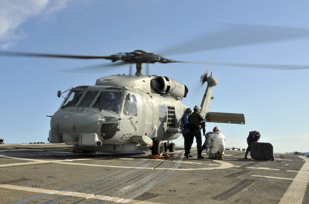 A US Navy SH-60B Seahawk helicopter is refueled on the flight deck of USS Thach Canvas Art - Stocktrek Images (35 x 23)