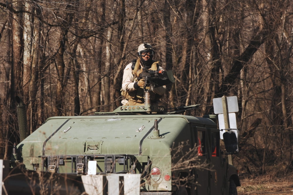 A US Navy Sailor mans a 50-caliber machine gun aboard a humvee Canvas Art - Stocktrek Images (34 x 23)