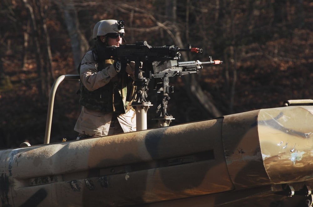 A US Navy Sailor mans the 240Gs port side machine gun aboard a small unit riverine craft Canvas Art - Stocktrek Images (34 x 23)