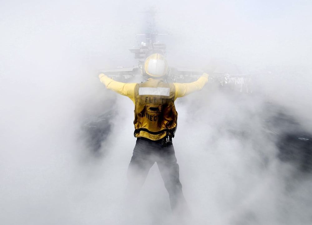 A US Navy flight deck director directs an EA-6B Prowler onto a steam-powered catapult Canvas Art - Stocktrek Images (34 x 24)