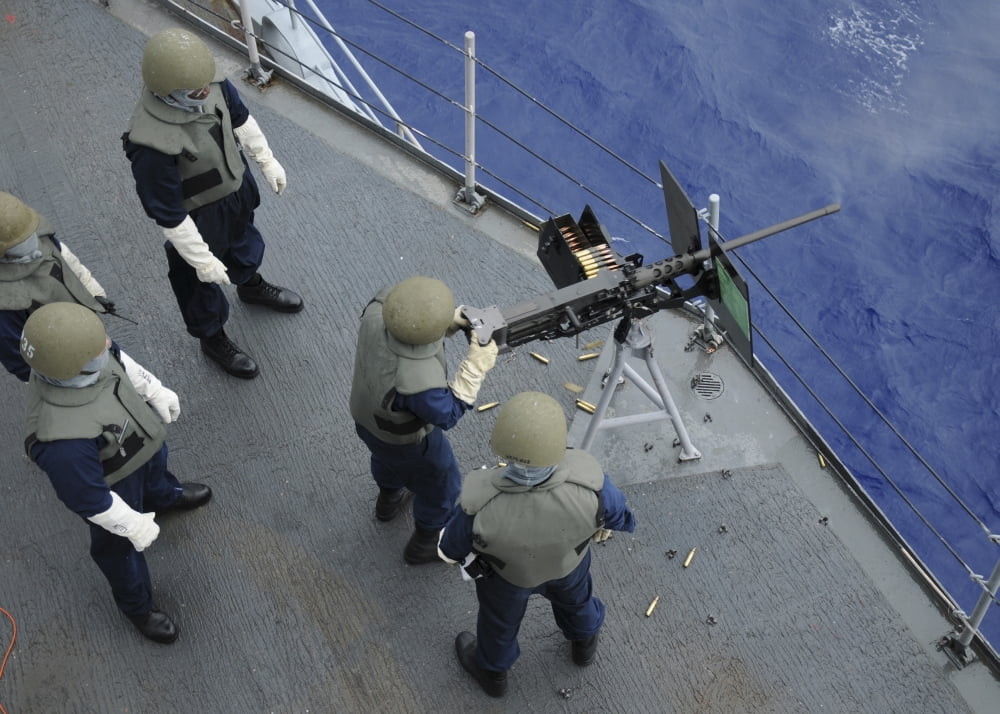 A US Sailor fires a 50-caliber M2HB machine gun aboard USS Frank Cable Canvas Art - Stocktrek Images (34 x 24)
