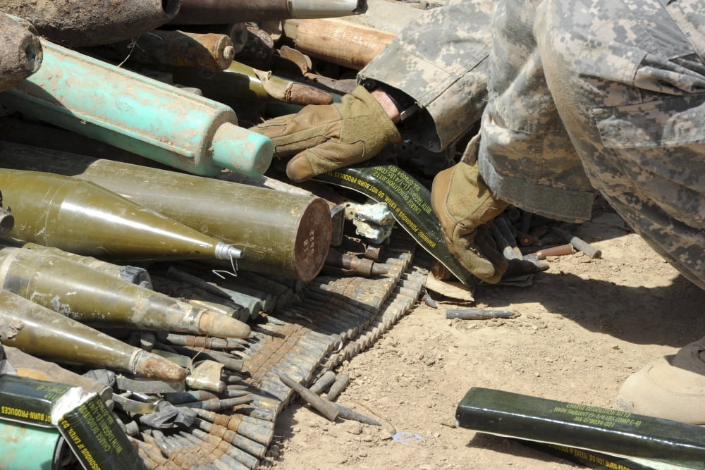 A US Soldier lays C-4 explosive sticks on top of unexploded ordnance ready for disposal Canvas Art - Stocktrek Images (34 x 23)