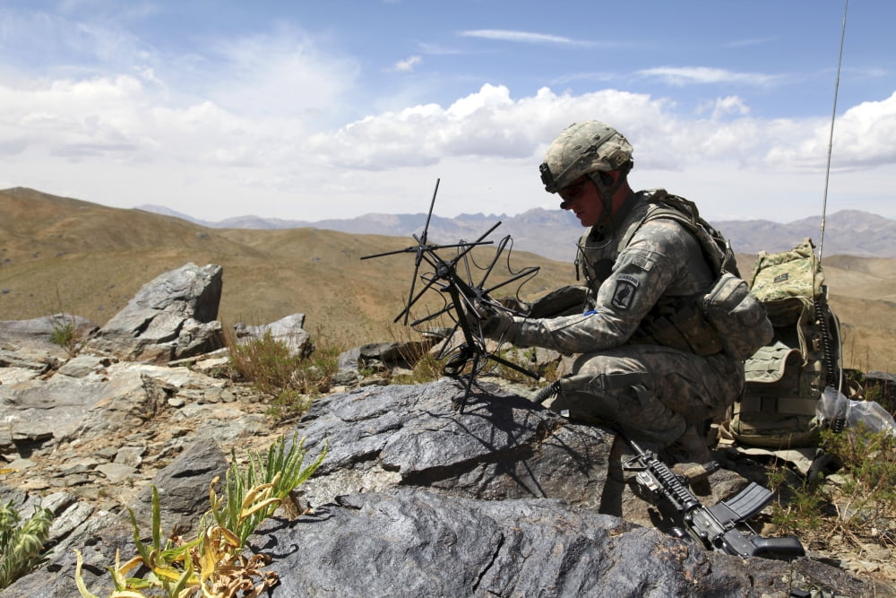 A US Soldier sets up a portable satellite system Canvas Art - Stocktrek Images (34 x 23)