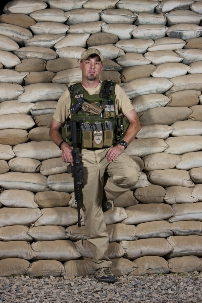 A US police officer contractor leans against his bunker in Afghanistan Canvas Art - Terry MooreStocktrek Images (12 x 18)