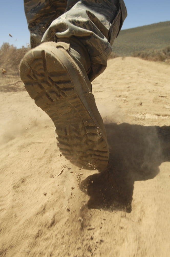 A US soldier walks along a dirt path at a training range near Hawthorne Nevada Canvas Art - Stocktrek Images (23 x 34)