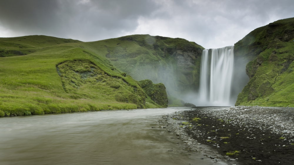 A Waterfall Over A Grassy Cliff Skogarfoss Iceland Canvas Art - David DuChemin Design Pics (40 x 22)