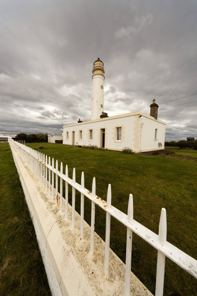 A White Fence Beside Barns Ness Lighthouse Lothian Scotland Canvas Art - John Short Design Pics (24 x 38)