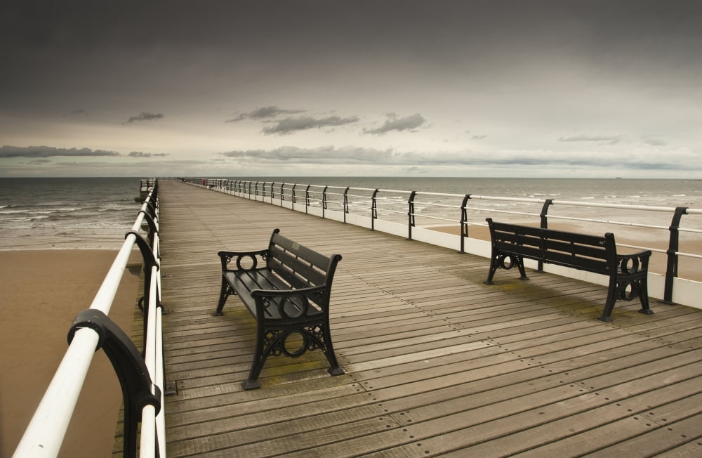 A Wooden Pier With Benches Looking Out Over The Beach And Water Saltburn Cleveland England Canvas Art - John Short Design Pics (19 x 12)