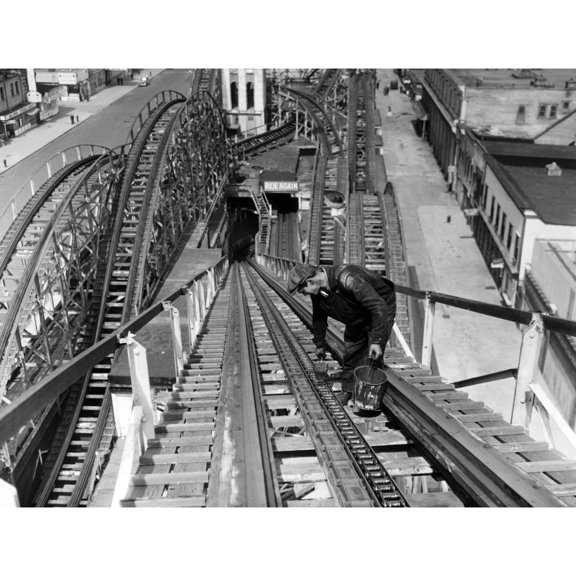 A Workman Greases Up The Tracks Of The Cyclone Roller Coaster In Coney Island. New York City History