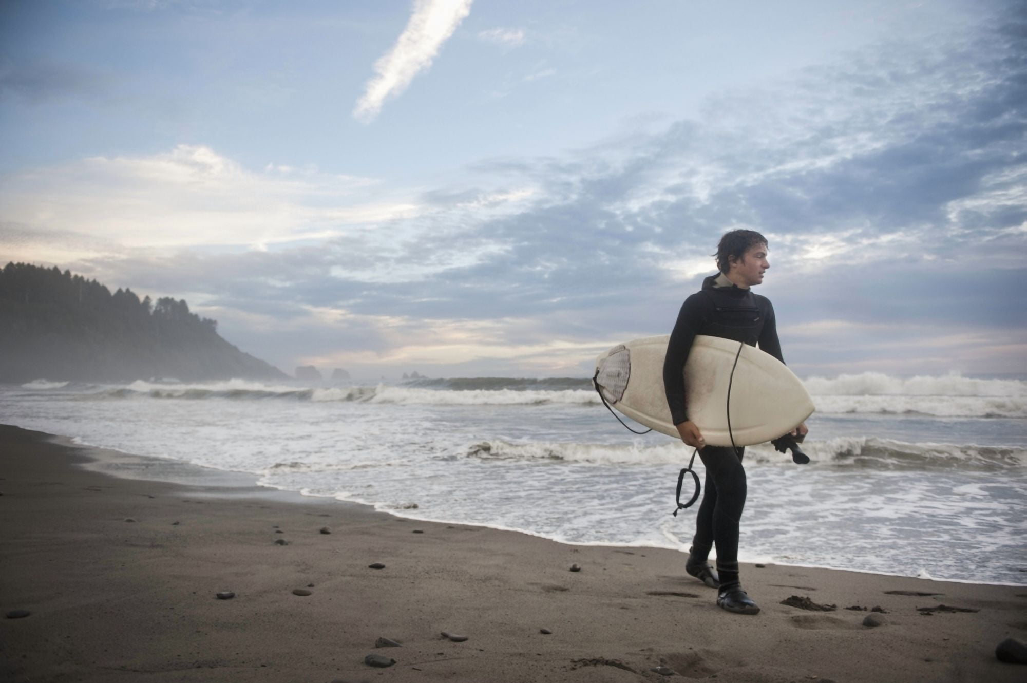A Young Man Carries His Surfboard Down The Beach La Push Washington United States Of America Canvas Art - Helene Cyr Design Pics (19 x 12)