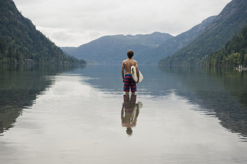 A Young Man Wearing A Swimsuit Stands In Cameron Lake British Columbia Canada Canvas Art - Helene Cyr Design Pics (38 x 24)