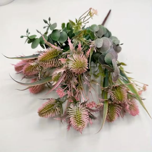 A bouquet of artificial flowers and artificial eryngium in a vintage autumn color scheme.