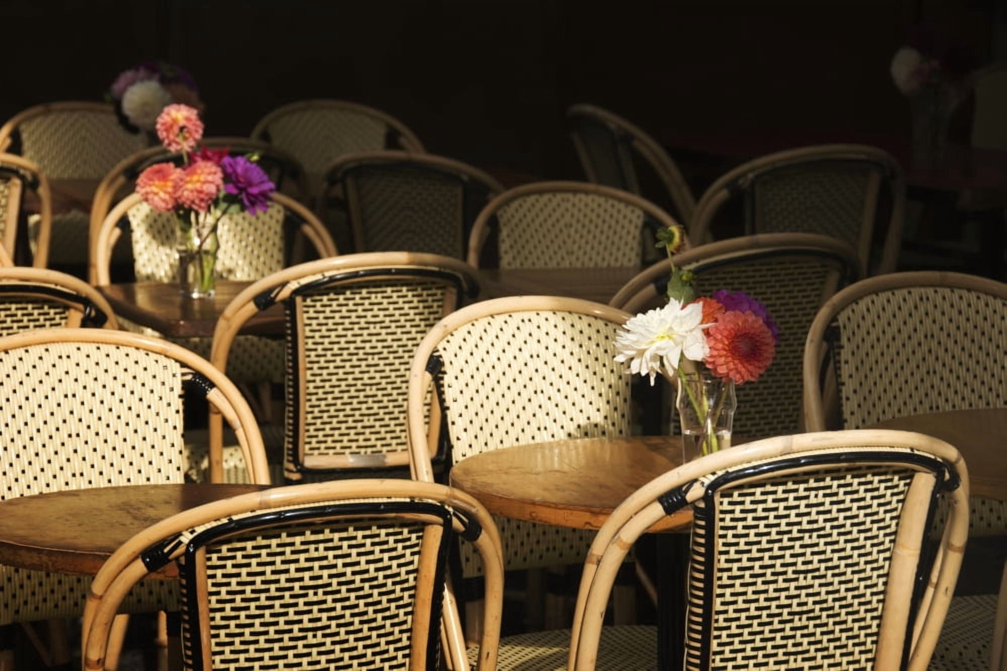 A bouquet of flowers amongst empty parisian bistro chairs and tables Paris France Canvas Art - Philippe Widling Design Pics (40 x 26)