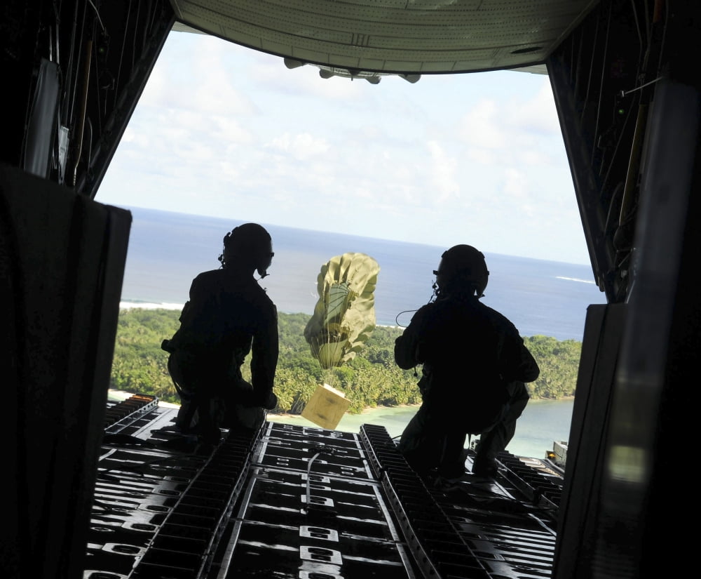 A box of humanitarian goods travels to the Yap Islands during Operation Christmas Drop Canvas Art - Stocktrek Images (31 x 25)