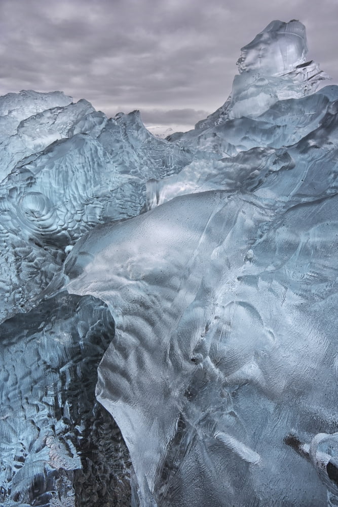 A close-up view of glacial ice strewn across a coastal beach iceland Canvas Art - Robert Postma Design Pics (24 x 38)