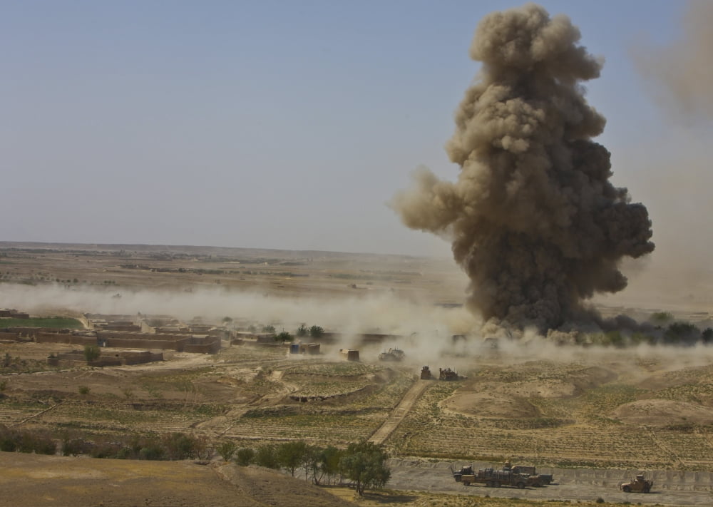 A cloud of dust and debris rises into the air in Afghanistan Canvas Art - Stocktrek Images (33 x 24)