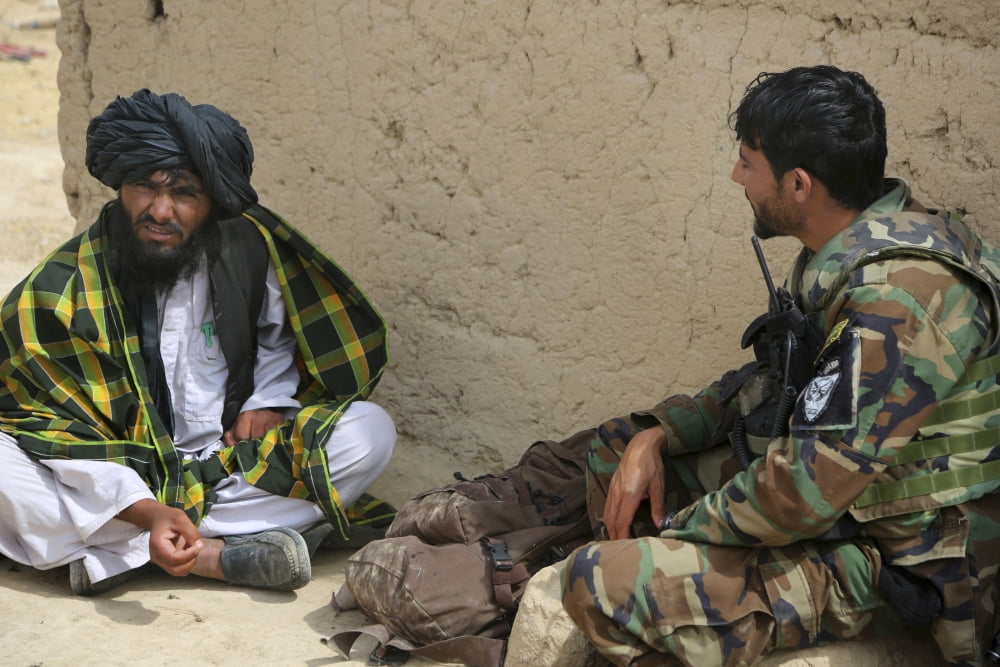 A commando from 3rd Special Operations Kandak speaks with a local villager Canvas Art - Stocktrek Images (34 x 23)