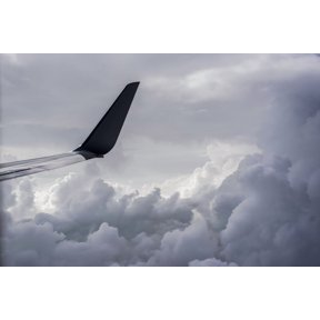 A commercial jet flies above the clouds over Illinois; United States of America Poster Print by Robert L. Potts / Design Pics (34 x 22)