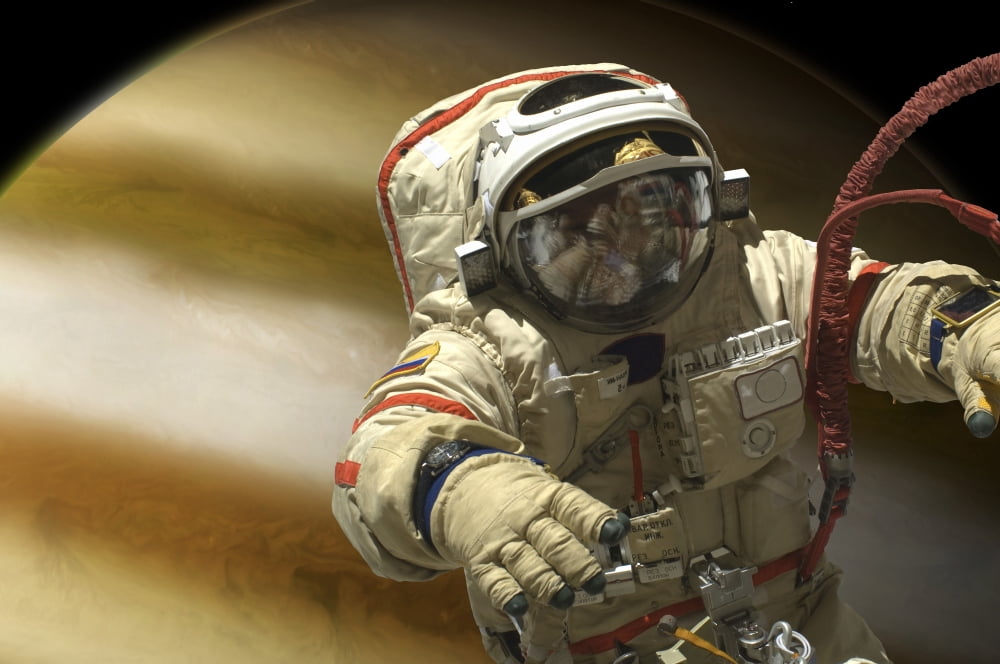 A cosmonaut floats in space above a large alien planet Canvas Art - Marc WardStocktrek Images (34 x 23)