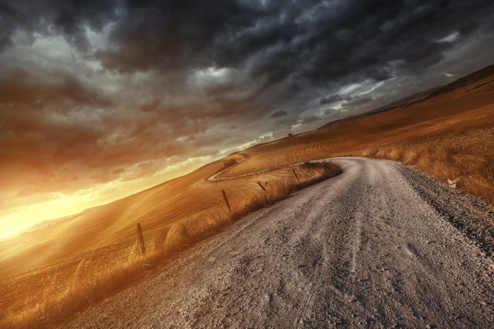 A country road in field at sunset against stormy clouds Tuscany Italy Canvas Art - Evgeny KuklevStocktrek Images (35 x 23)
