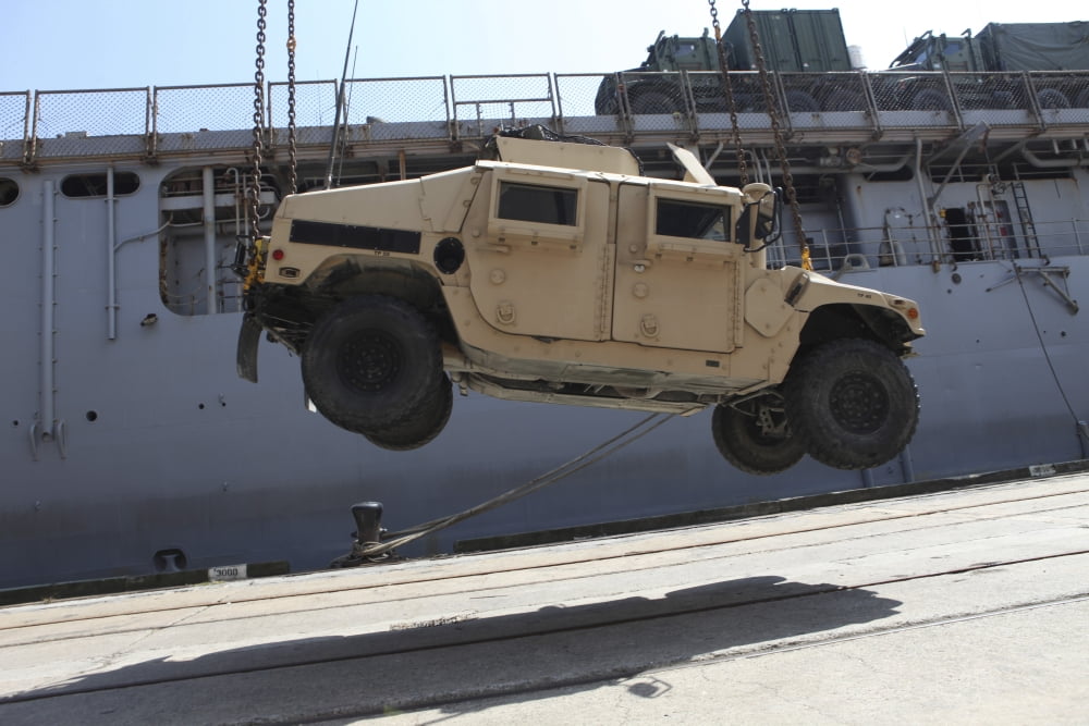 A crane lifts an M998 Humvee on the flight deck of USS Carter Hall Canvas Art - Stocktrek Images (35 x 23)