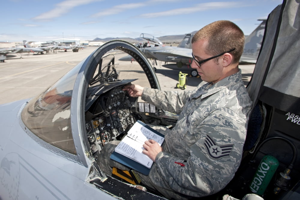A crew chief goes over the radios in the F-15 cockpit Canvas Art - HIGH-G ProductionsStocktrek Images (35 x 23)