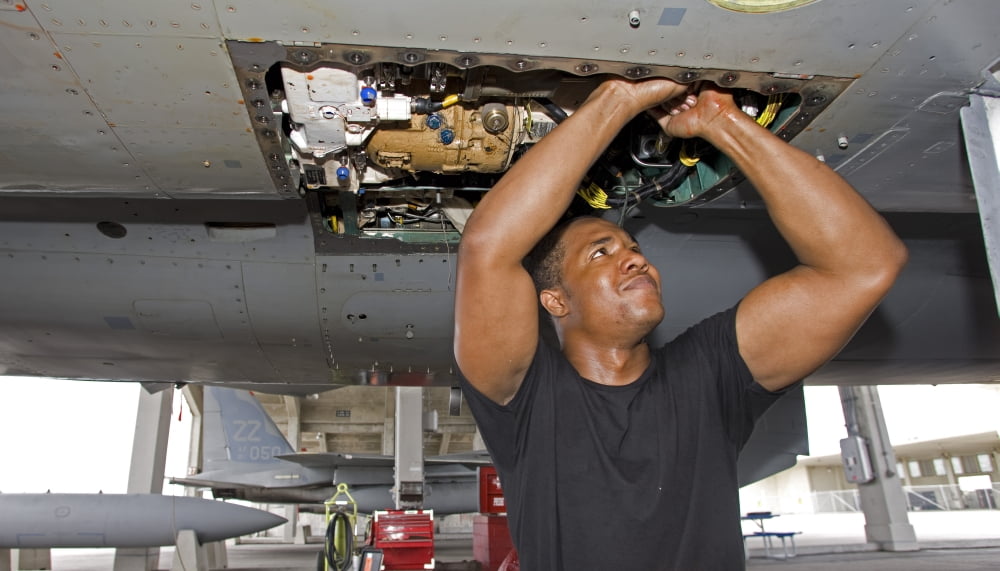 A crew chief performs work on an F-15 Eagle Canvas Art - HIGH-G ProductionsStocktrek Images (19 x 11)