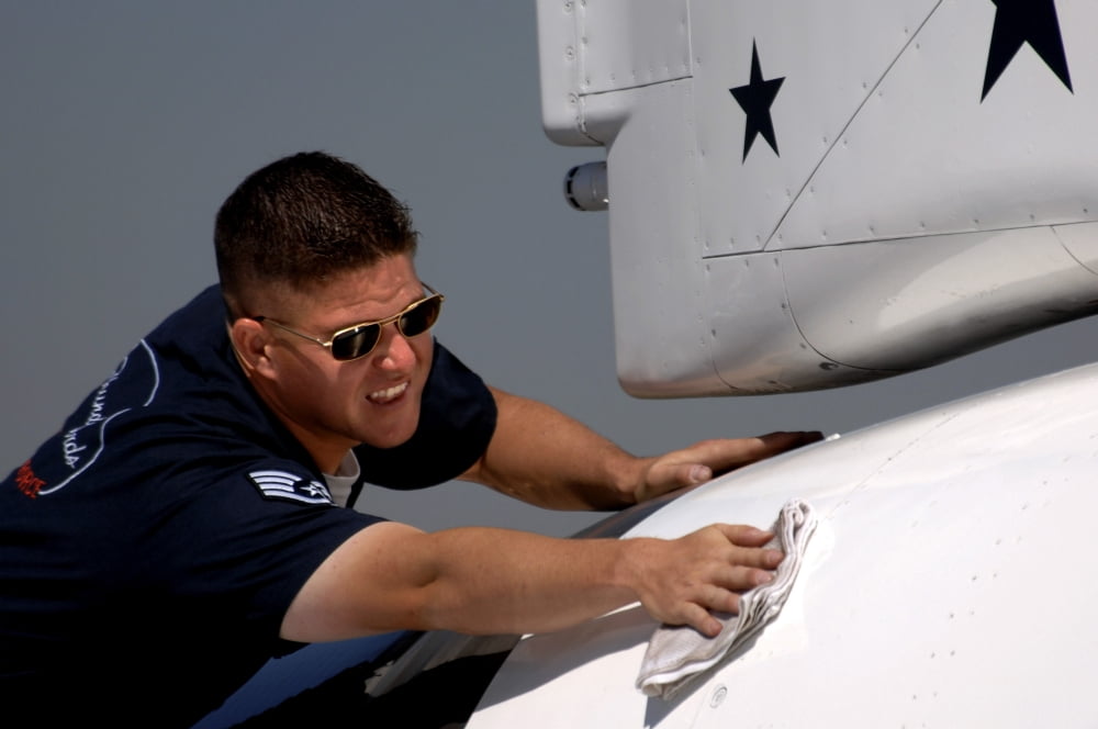 A crew chief touches up one of the jets of the Air Force Thunderbirds Canvas Art - Stocktrek Images (34 x 23)