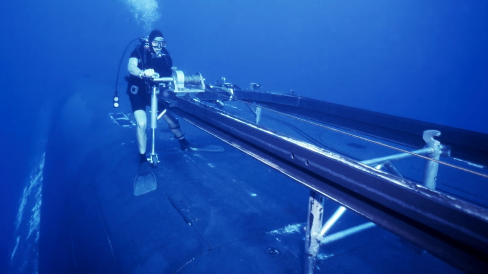 A crewman cranks out the Dry Deck Shelter cradle from USS Kamehameha Canvas Art - Michael WoodStocktrek Images (19 x 11)