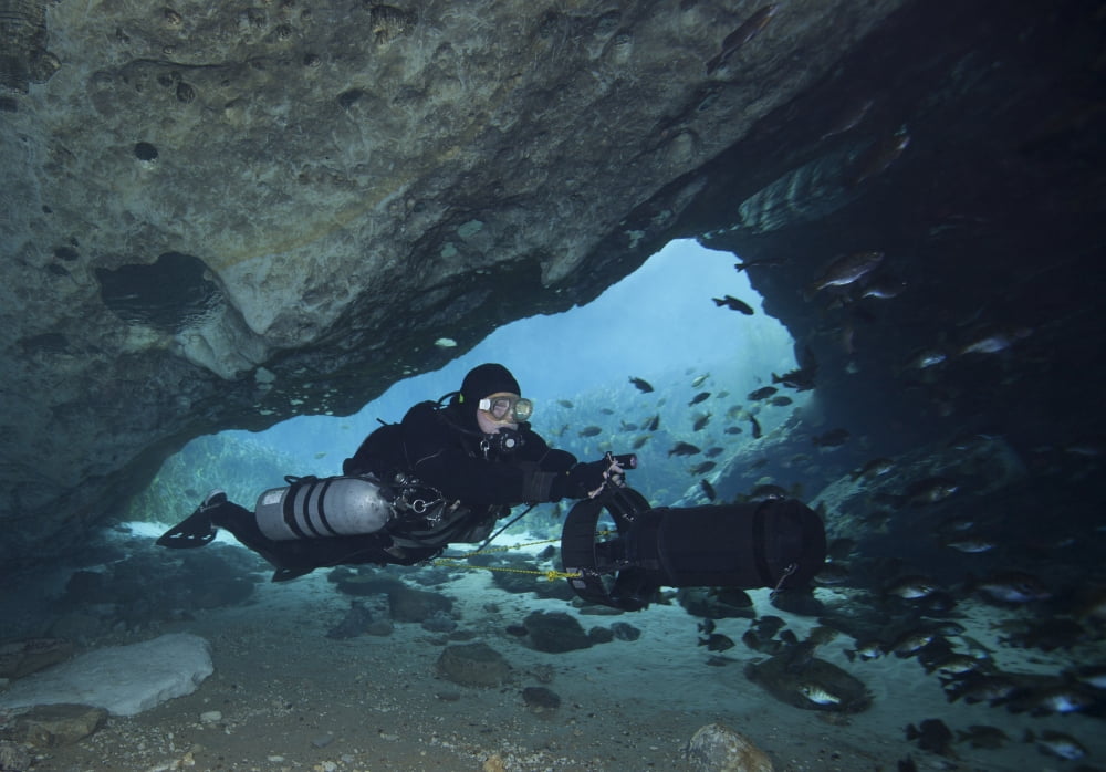 A diver using a diver propulsion vehicle in the Blue Springs cave system Canvas Art - Michael WoodStocktrek Images (34 x 24)