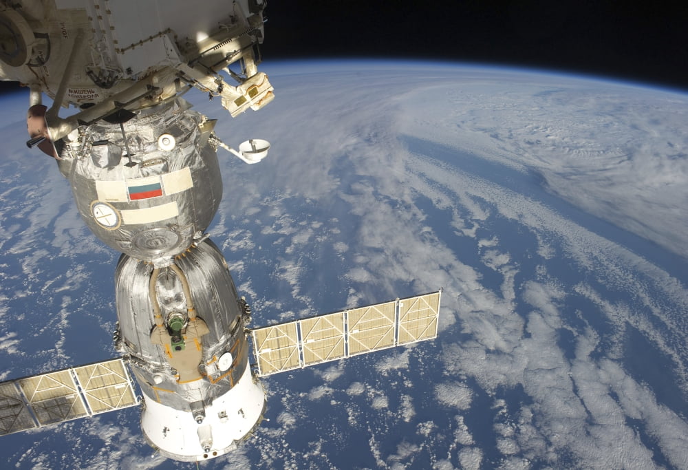 A docked Russian Soyuz spacecraft backdropped by Earth Canvas Art - Stocktrek Images (34 x 24)