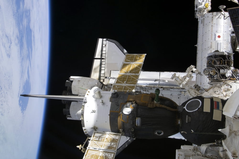 A docked Soyuz spacecraft over the docked space shuttle Atlantis Canvas Art - Stocktrek Images (34 x 23)