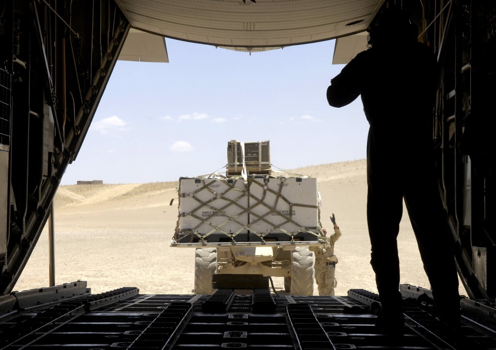A forklift loads cargo onto a C-130 Hercules Canvas Art - Stocktrek Images (33 x 23)