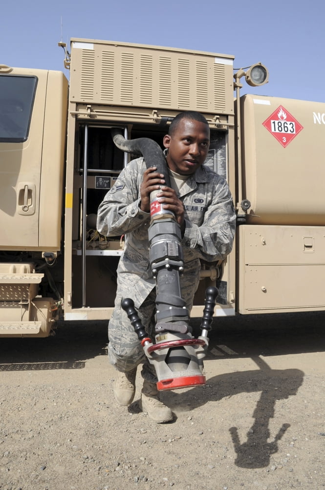 A fuels distribution apprentice pulls out a hose on an R-11 fuels truck Canvas Art - Stocktrek Images (23 x 34)