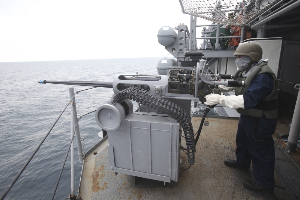 A gunner mans a Mk-38 machine gun aboard USS Kearsarge Canvas Art - Stocktrek Images (35 x 23)