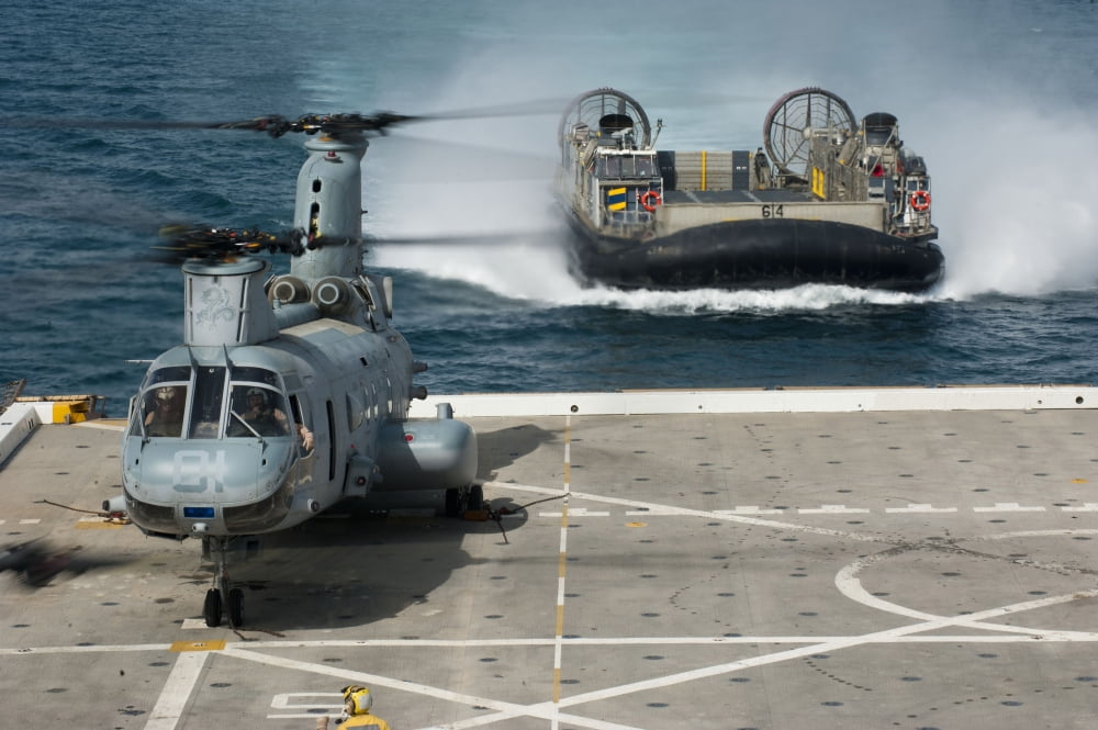 A hovercraft approaches USS New Orleans as a CH-46E Sea Knight sits on the flight deck Canvas Art - Stocktrek Images (35 x 23)