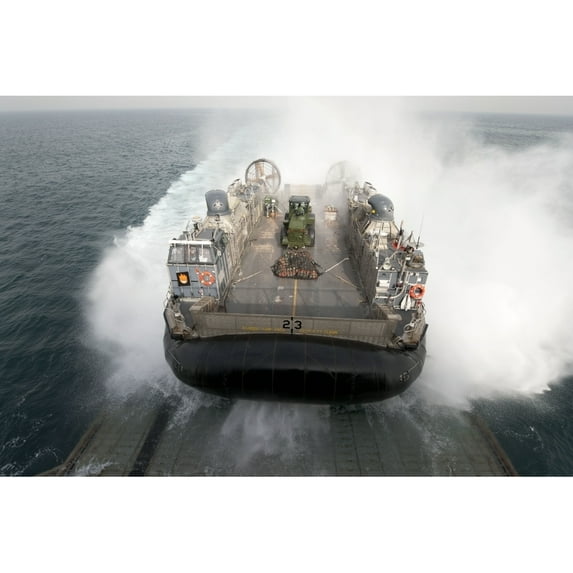 A landing craft air cushion enters the well deck of USS Pearl Harbor Poster Print